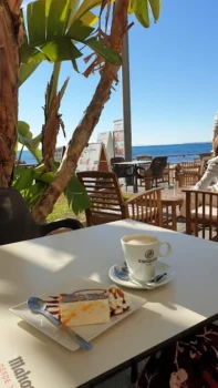 Café y tarta con vista al mar